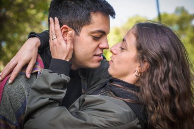Closeup tenderly cheerful and romantic couple hugging and enjoying in love in nature outdoor. Love, relationship and romance concept. Girlfriend and boyfriend dating