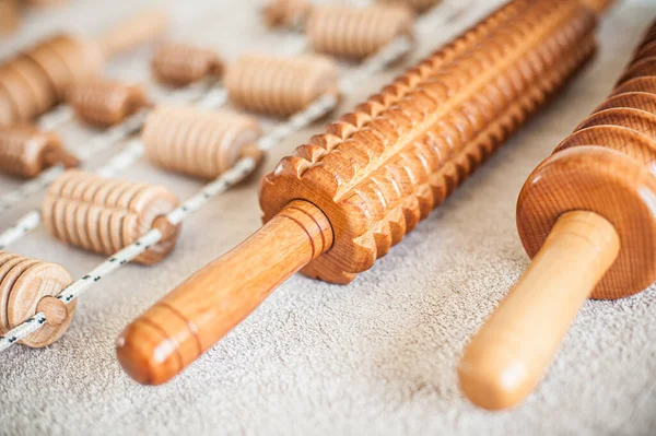 Wood massage, maderotherapy, wooden rolling pin or battledore tools for anti cellulite treatment to stimulate the lymphatic system and improve circulation concept
