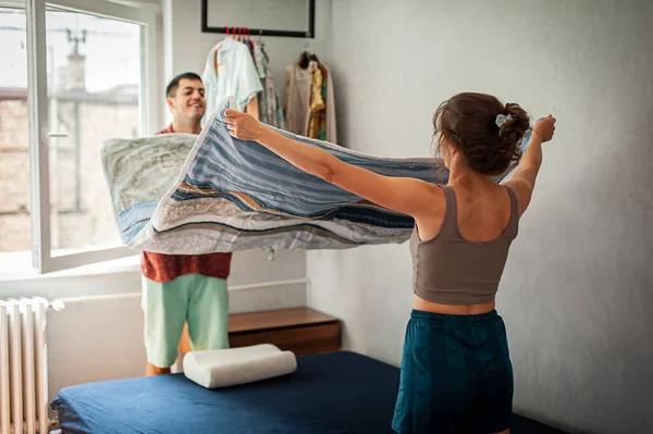 Cheerful Young Couple Making Bed Having Fun Home Doing House — 图库照片