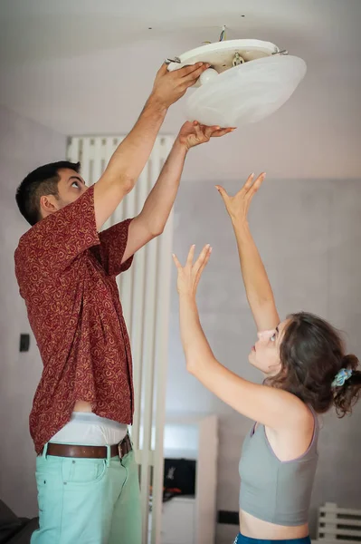Living Together Young Man Woman Install Ceiling Light Electrical Cables — стоковое фото