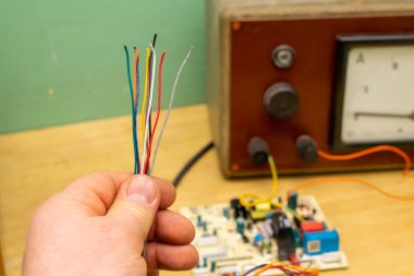 Elinde elektrik kabloları, laboratuvar.