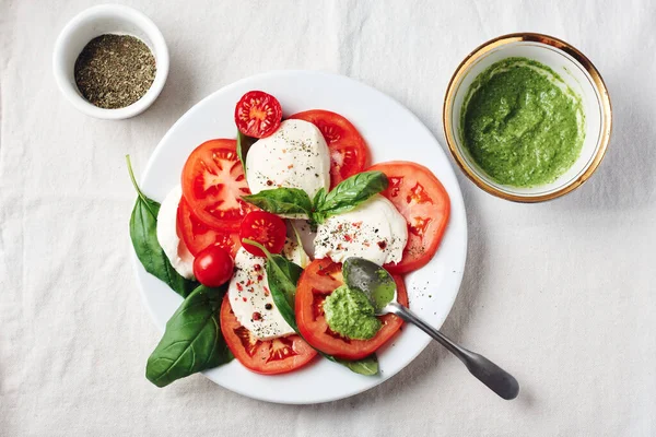 Caprese salatası. Domates, mozarella peyniri, fesleğen yaprağı ve pesto sosu..