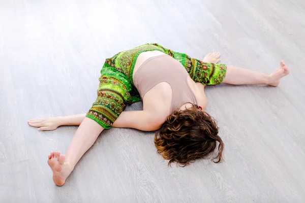Mujer yogui deportiva haciendo ejercicios de fitness, yoga asana Kurmasana, postura de tortuga, Turtle Pose vista superior — Foto de Stock