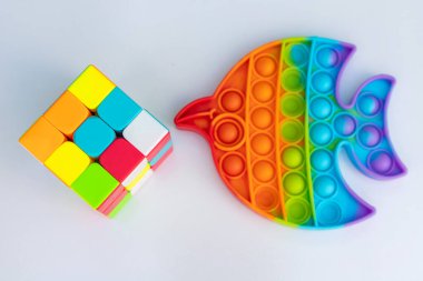 Puzzle cube and pop it silicon toys on a white isolated background