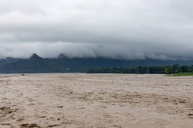 Heavy flood in the valley wash away crops and fields nearby the river bank
