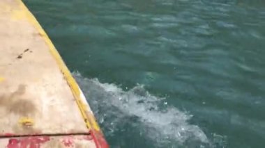Colourful wooden boat moving fast in the mahodand lake, kalam