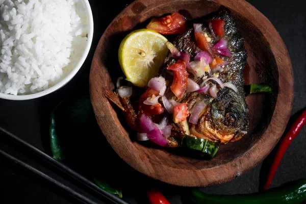 fried pomfret on wooden disk with rice bowl. suitable for kitchen banner