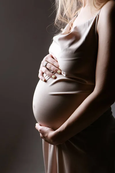 Caucasian pregnant woman stroking her belly on white background. Copy space. The concept of healthy digestion, lifestyle, IVF — Stock Photo, Image