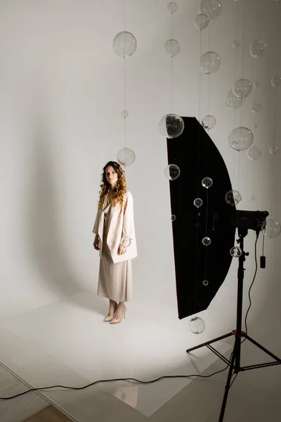 Um modelo com uma bela maquiagem no estúdio em um fundo branco. tiro profissional e iluminação no estúdio — Fotografia de Stock