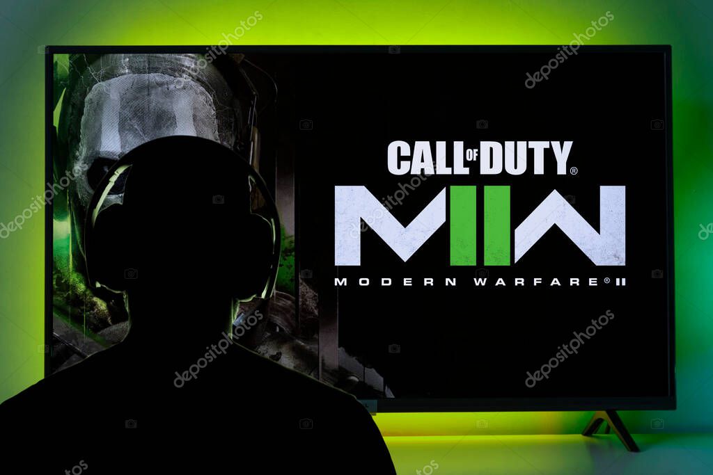 Man with headphone playing Call of Duty Modern Warfare II on TV screen. 22 Sep, 2022, Sao Paulo, Brazil.