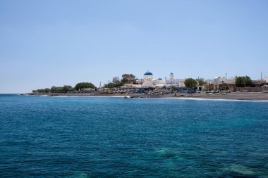 View of famous volcanic beach and bay of Perissa village, Santorini island, Cyclades, Greece