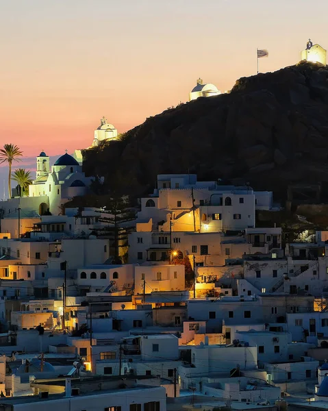 Panoramic view of the picturesque illuminated island of Ios in Greece while the sun is setting