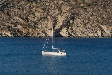 View of a beautiful yacht  at the beach of Mylopotas in Ios, Greece