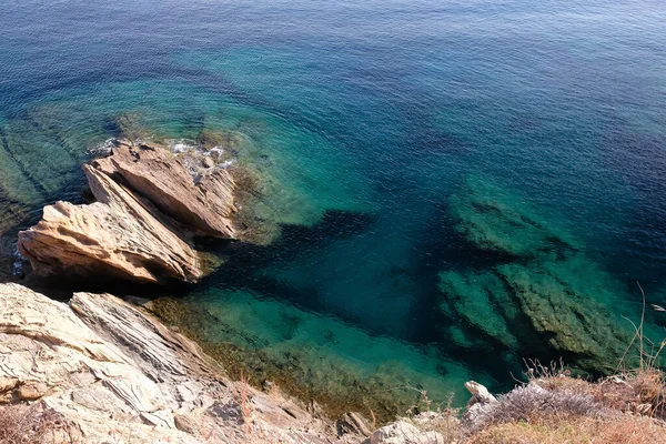 Beautiful turquoise waters next to rocks in Ios cyclades Greece