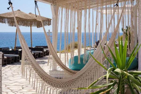 Beautiful view of the Aegean Sea from a restaurants terrace with hammocks in Ios Greece