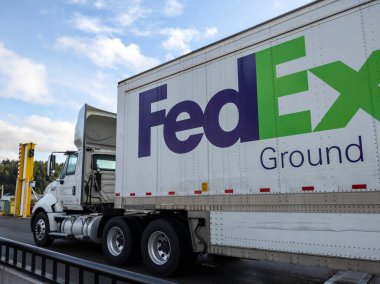 Friday Harbor, WA USA - circa November 2021: View of a FedEx freight truck boarding a Washington State Ferry on a bright, sunny day.