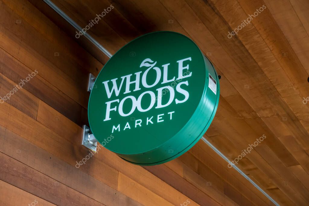 Kirkland, WA USA - circa July 2021: Low angle view of a Whole Foods Market circular sign.