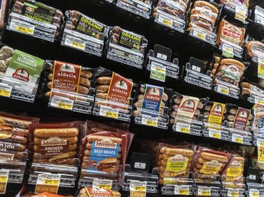 Woodinville, WA USA - circa April 2022: Angled view of the hot dogs and brats section of a Haggen grocery store. clipart