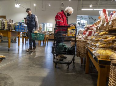 Mill Creek, WA USA - circa May 2022: View of an elderly man shopping in the breads and pastries section of a Town and Country grocery store