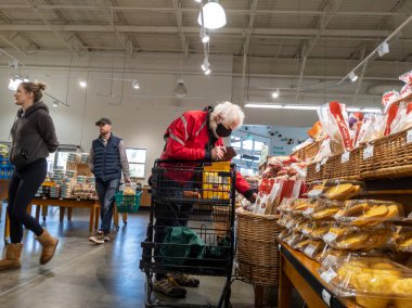 Mill Creek, WA USA - circa May 2022: View of an elderly man shopping in the breads and pastries section of a Town and Country grocery store