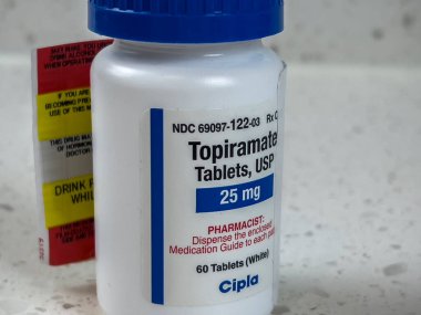 Seattle, WA USA - circa May 2022: Close up view of an angled bottle of Topiramate medication.