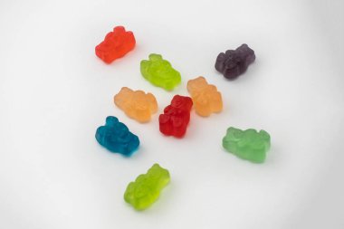 Colorful set of CBD infused medicinal candy gummies used for healing on a plain white background