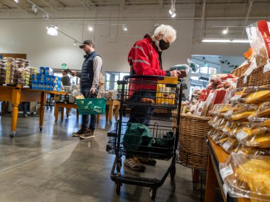 Mill Creek, WA USA - circa May 2022: View of an elderly man shopping in the breads and pastries section of a Town and Country grocery store