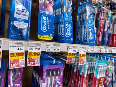 Everett, WA USA - circa June 2022: Angled close up of a variety of toothbrushes for sale inside a Fred Meyer grocery store.