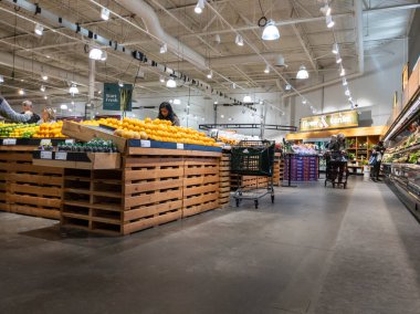 Mill Creek, WA USA - circa June 2022: Wide angle view of people shopping in the produce section of a Town and Country Market.