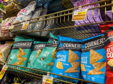 Woodinville, WA USA - circa May 2022: Angled view of Pop Corners brand corn chips for sale inside a Haggen grocery store.