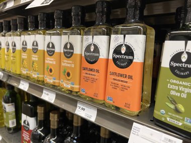 Mill Creek, WA USA - circa June 2022: Angled, selective focus on cooking oils for sale inside a Town and Country grocery store