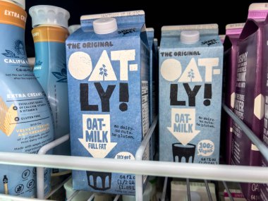 Everett, WA USA - circa August 2022: Angled, selective focus on Oatly milk alternative products for sale inside an Albertsons grocery store