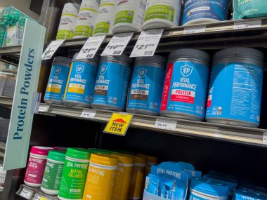 Mill Creek, WA USA - circa May 2022: Angled, selective focus on a variety of protein powders and supplements inside a Town and Country Market.
