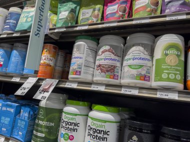 Mill Creek, WA USA - circa May 2022: Angled, selective focus on a variety of protein powders and supplements inside a Town and Country Market