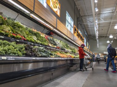 Mill Creek, WA USA - circa June 2022: Wide view of people shopping in the produce section of a Town and Country grocery store.