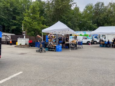 Mill Creek, WA USA - circa August 2022: Wide view of people shopping for groceries at a food pantry at a local church.
