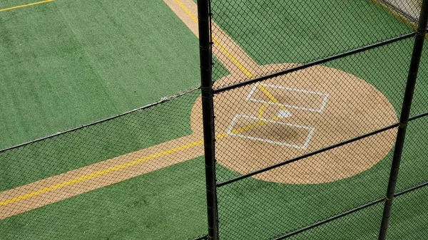 Angled view of a large, empty baseball field on an overcast day