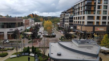 Kirkland, WA / USA - circa December 2021: Rooftop view of traffic intersection near Kirkland Urban apartments and shops near Park Place Plaza in downtown Kirkland, off of Central Way