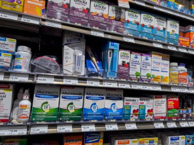 Mill Creek, WA USA - circa May 2022: Angled, selective focus on cold, cough, and flu medicine for sale inside a Town and Country Market