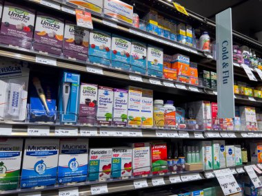 Mill Creek, WA USA - circa May 2022: Angled, selective focus on cold, cough, and flu medicine for sale inside a Town and Country Market