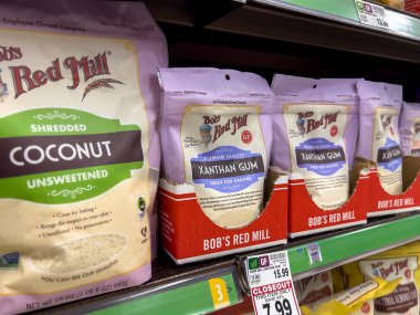 Seattle, WA USA - June 2022: Angled view of Xanthan gum and coconut shreds for sale inside a grocery store.