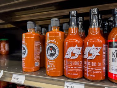 Mill Creek, WA USA - circa August 2022: Close up, selective focus on sriracha hot sauce inside a Town and Country Market