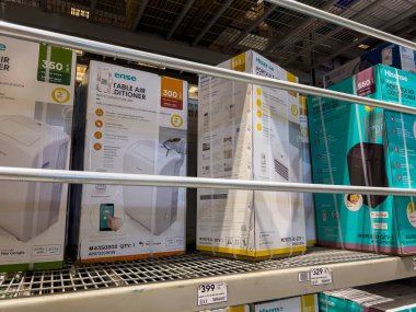 Seattle, WA USA - circa July 2022: Selective, angled focus on air conditioners for sale inside a Lowes Home Improvement store.