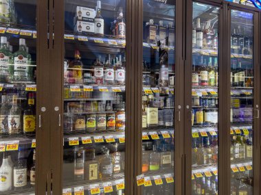Seattle, WA USA - circa August 2022: Angled view of a locked up liquor cabinet inside a QFC grocery store.