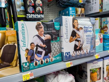Lynnwood, WA USA - circa September 2022: Close up view of baby carriers for sale inside a Walmart superstore. clipart