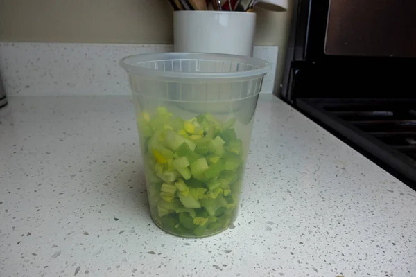 View Coloful Diced Celery Plastic Container Kitchen Counter Prepped Cooking — Stock Photo, Image