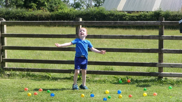 Małe Dziecko Bawiące Się Kulkami Zabawkami Trawniku Ogrodzie Słoneczny Dzień — Zdjęcie stockowe