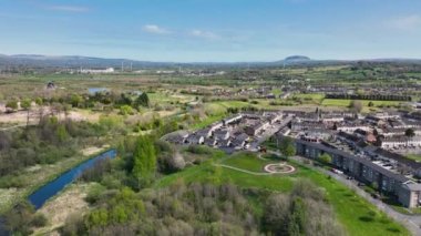 Aerial Video of Ballykeel residential buildings Braid River and Slemish Mountain Ballymena Co Antrim Northern Ireland