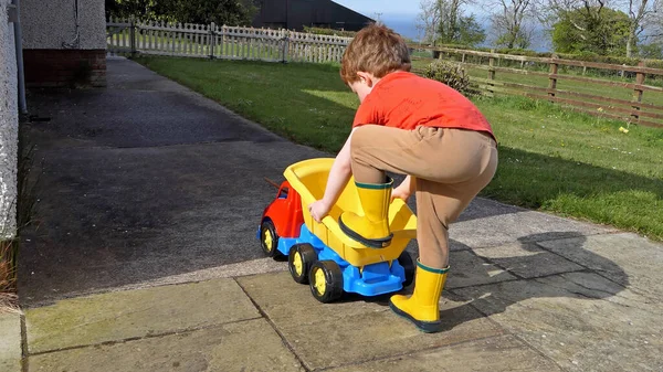 Red Headed Boy Having Fun Playing His Toys Garden — 图库照片