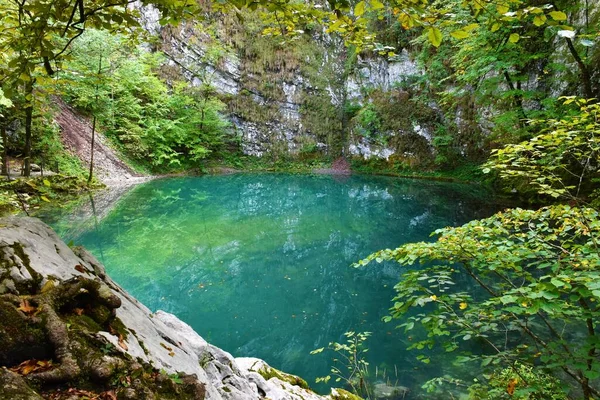View of turquoise colored Divje jezero or Wild lake near Idrija in Primorska, Slovenia in summer
